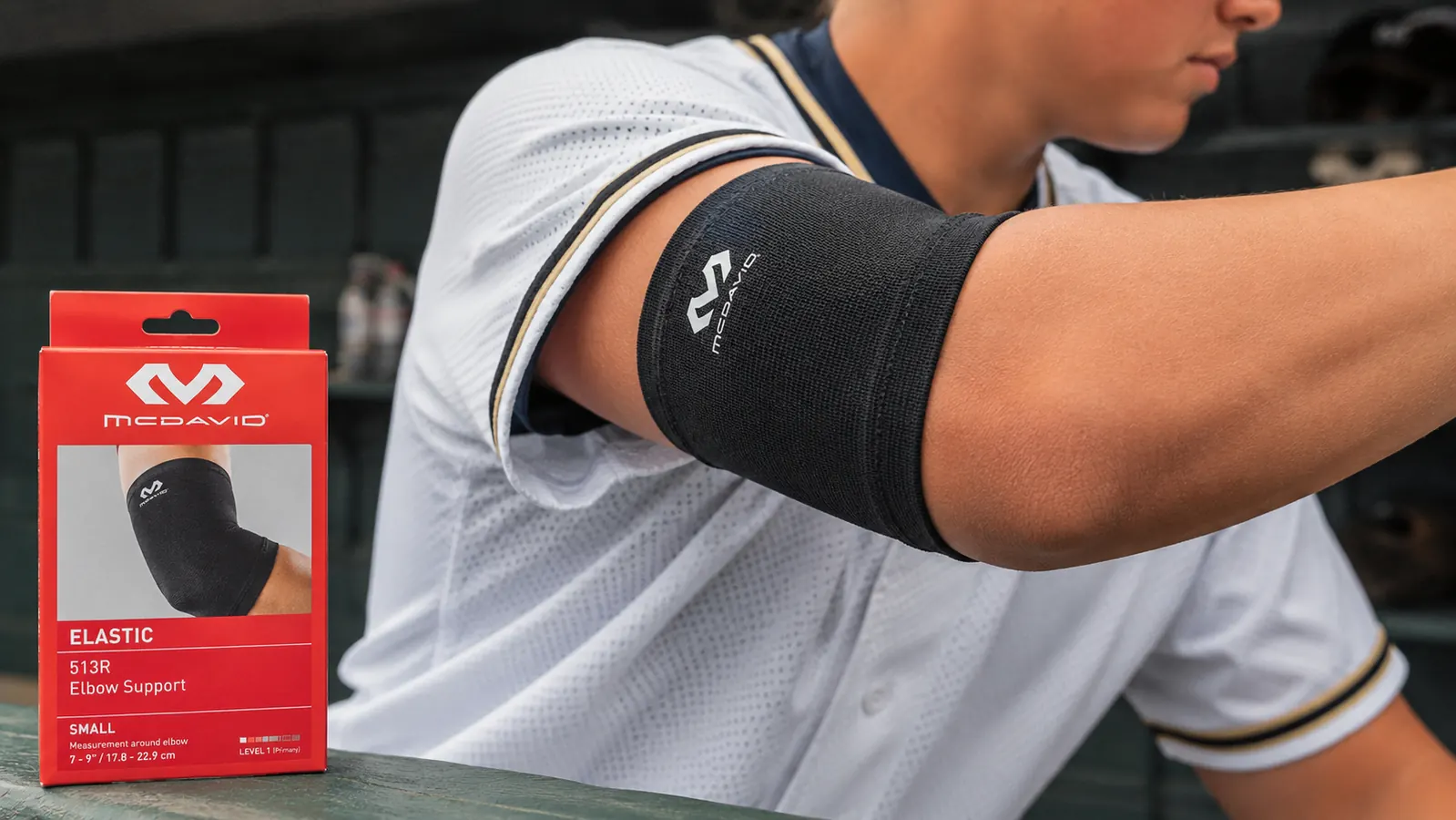 McDavid elastic elbow support shown from multiple angles including how it sits under a baseball jersey sleeve