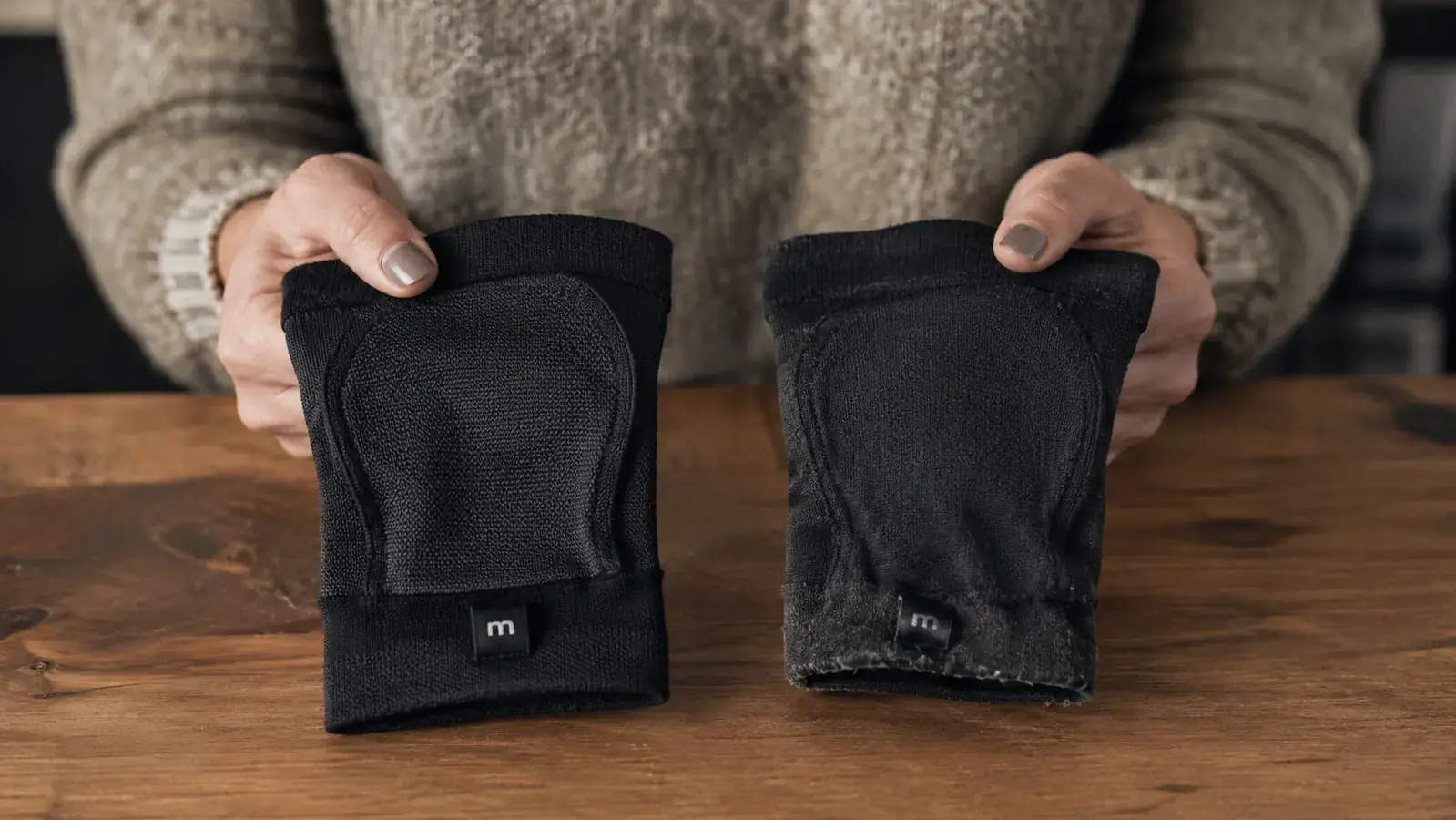 Parent holding two compression sleeves side by side, one new and one worn after several months of use